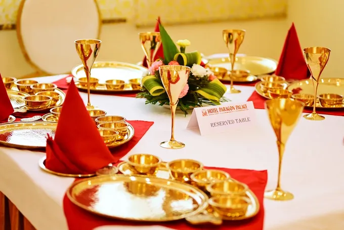 A banquet table laid in brass
