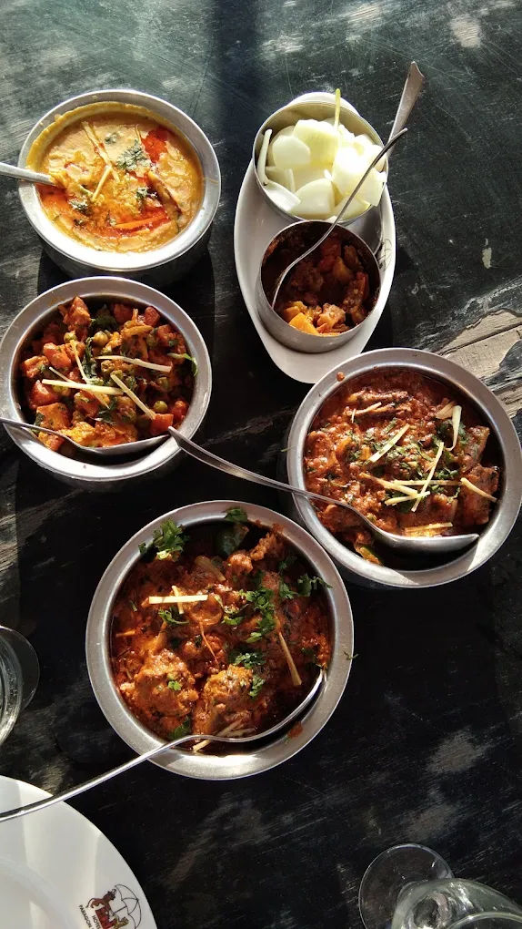 Bowls of North Indian and Himachali curries served in steel katoris