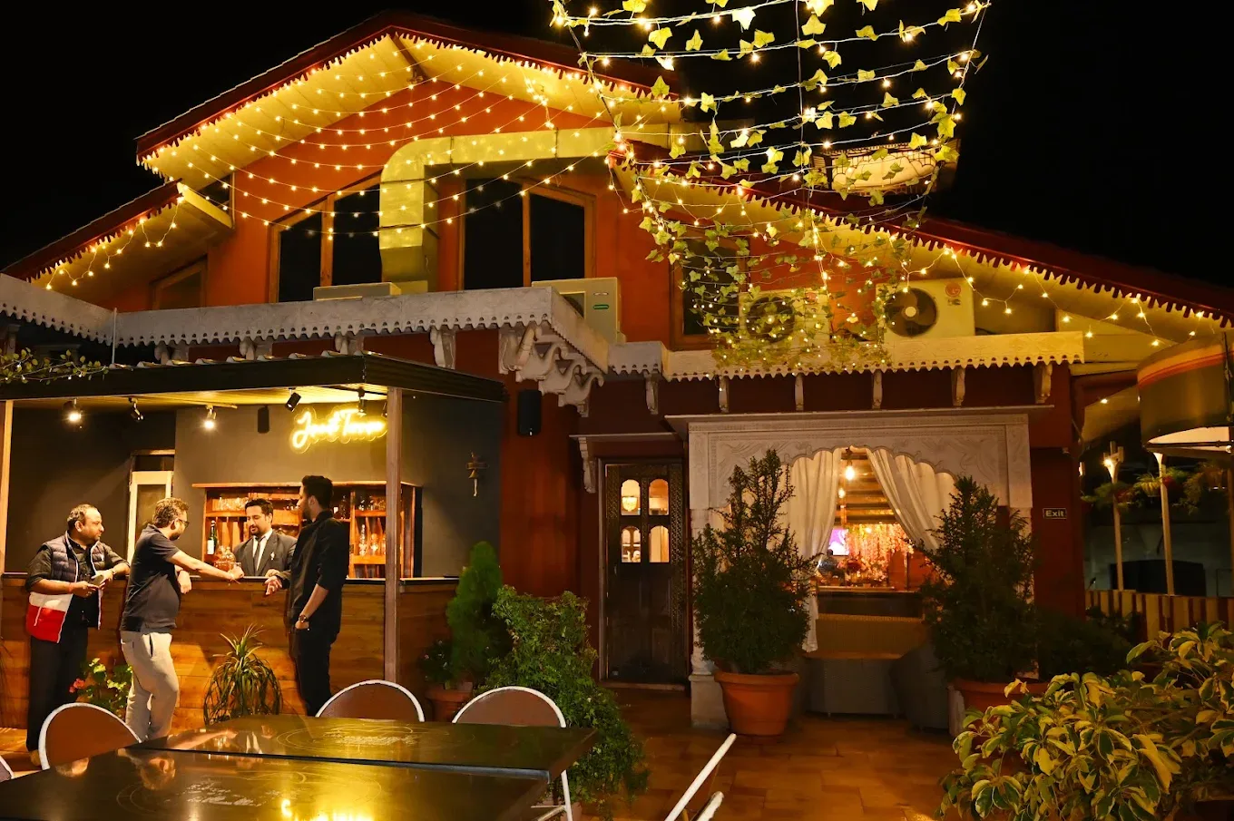 The terrace bar and restaurant frontage lit with fairy lights in the evening